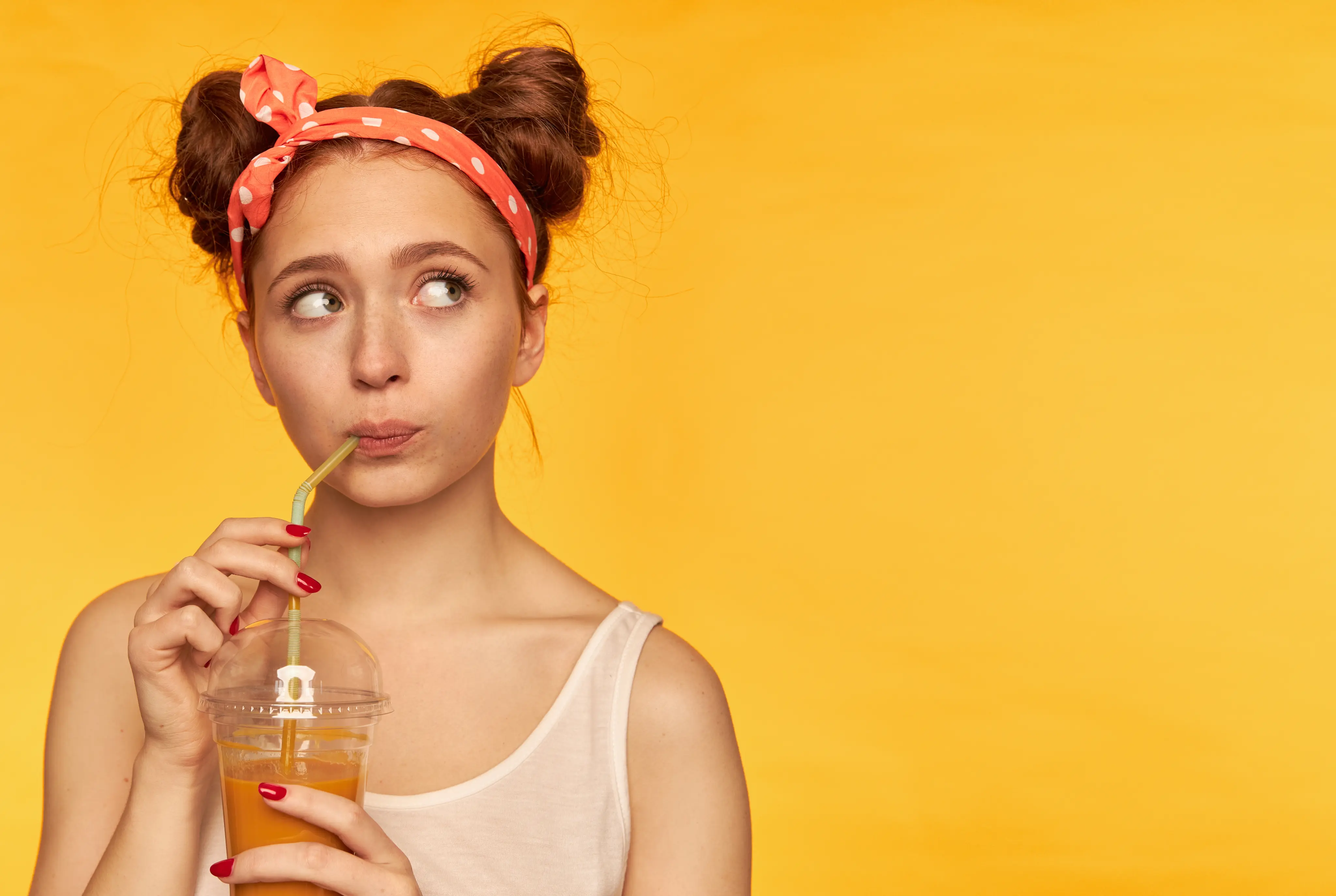 Happy woman drinking juice